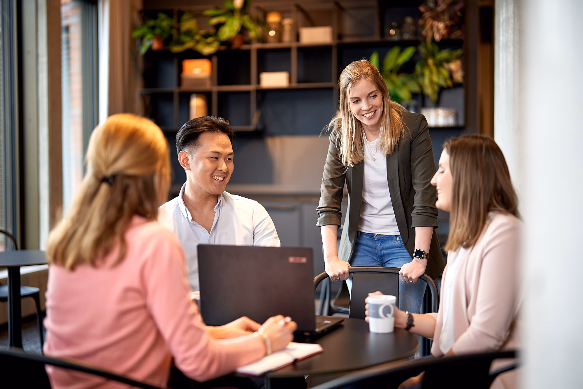 casusQuo team talking at a desk