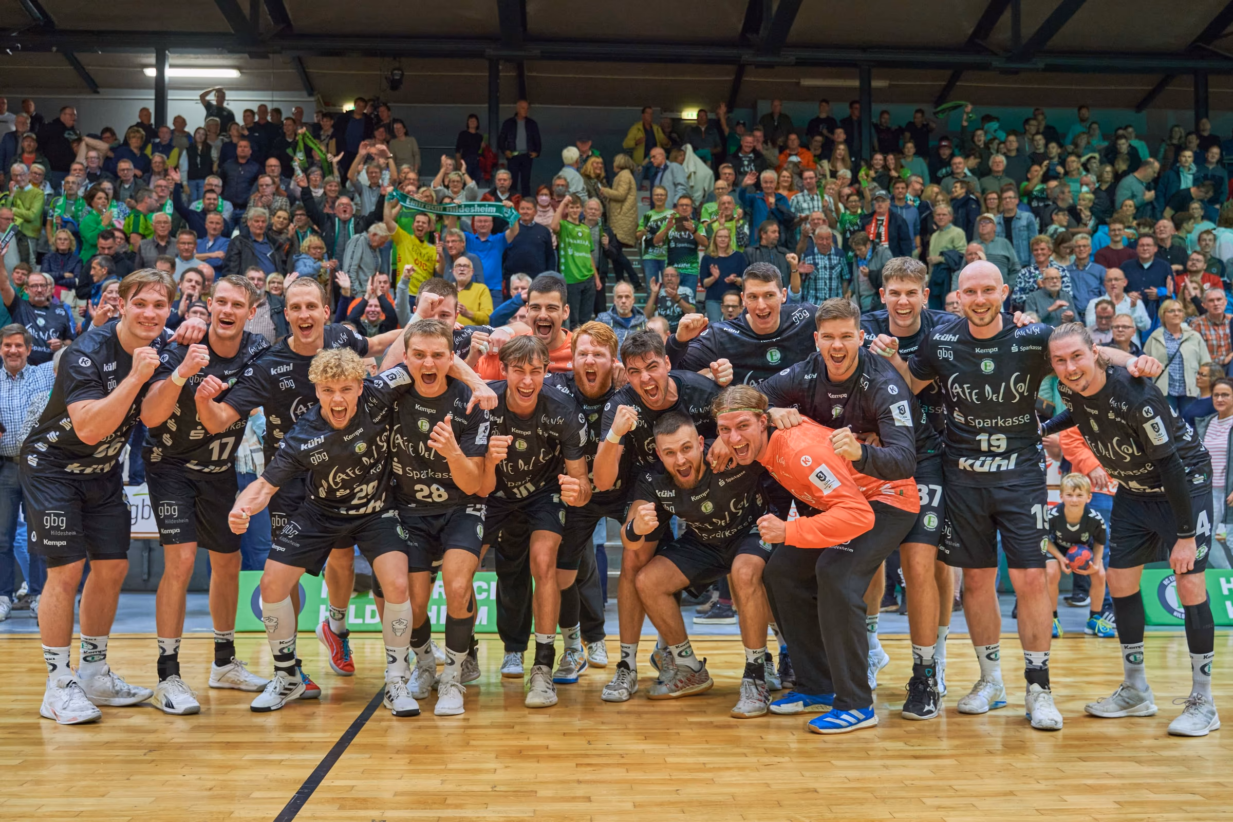 Eintracht Hildesheim team celebrating in front of the fans
